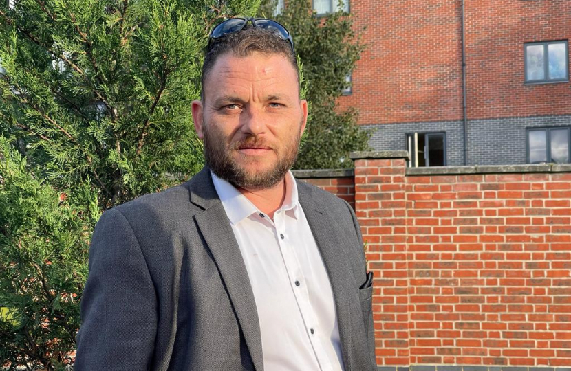 James Clifford, candidate for Plaistow North, standing by a tree and wall.