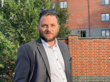 James Clifford, candidate for Plaistow North, standing by a tree and wall.