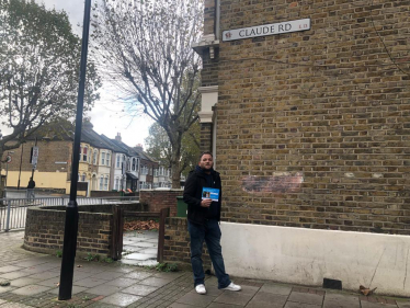  James Clifford standing by the sign for Claude Road